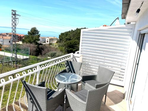 a patio with chairs and a table on a balcony at Apartments Toni in Podstrana