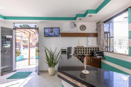 a kitchen with green and white stripes on the wall at Pousada Santa Fé in Aracaju