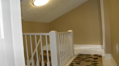 a hallway with a white staircase with a ceiling at Petoskey Grove in Petoskey