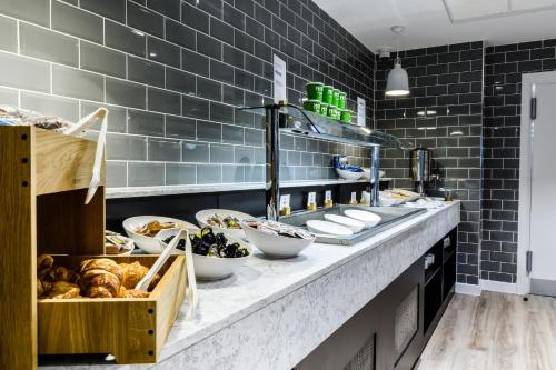 a bakery counter with a bunch of food on it at Holiday Inn Express - Wigan, an IHG Hotel in Wigan