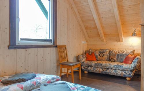 a room with a couch and a chair in a cabin at Haus Panoramablick in Lennestadt