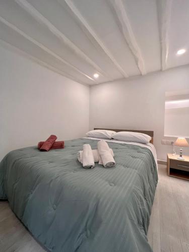 a bedroom with a large bed with towels on it at Camara’s Gem in Poros