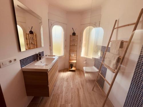 a bathroom with a sink and a mirror at Denia Dream Seaview Golf, Tennis & Beach Villa in Muntanya la Sella