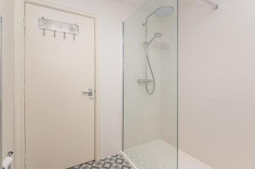 a shower with a glass door in a bathroom at Flat 2 Peter Lane Cosy 1-Bed Flat in the Heart of York City Centre Pass the Keys in York
