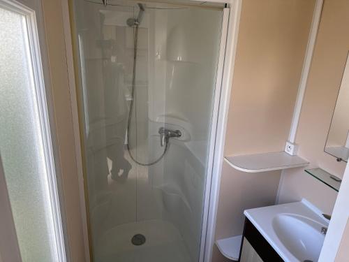 a bathroom with a shower with a toilet and a sink at Mobilhome 6 personnes in Saint-Georges-de-Didonne