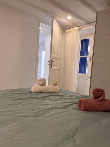 a bedroom with a bed with two towels on it at Camara’s Gem in Poros