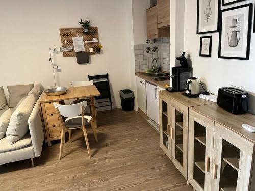 a kitchen and living room with a couch and a table at 1 Zimmer Wohnung mit der Terrasse in der Innenstadt in Wiesbaden