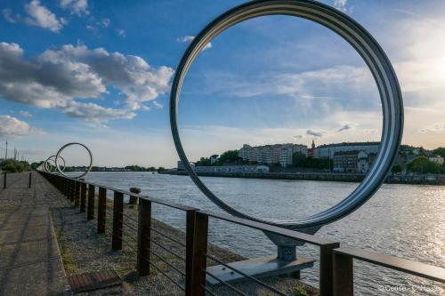 a large mirror on a fence next to a river at Cerise Nantes La Beaujoire in Nantes