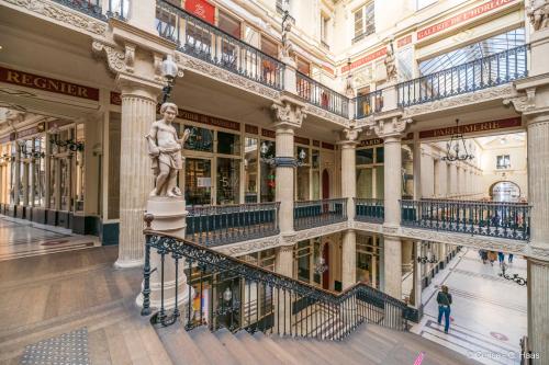 a building with a statue in the middle of it at Cerise Nantes La Beaujoire in Nantes