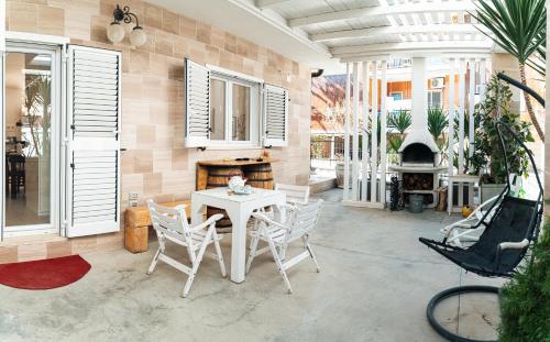 a patio with a table and chairs and a fireplace at Villa Eletti in Matera