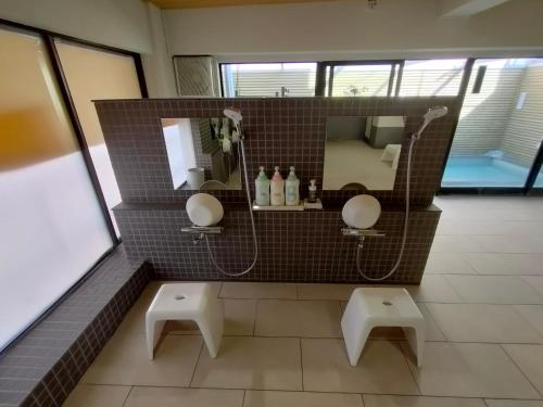 a bathroom with two sinks and a shower with a mirror at Hotel Edoya in Tokyo