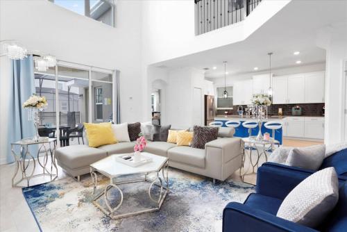 a living room with a couch and a table at Modern Resort House Pool Wi-Fi Minutes to Disney in Kissimmee