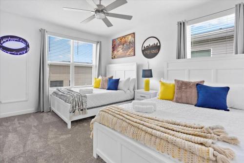 a bedroom with two beds and a ceiling fan at Modern Resort House Pool Wi-Fi Minutes to Disney in Kissimmee
