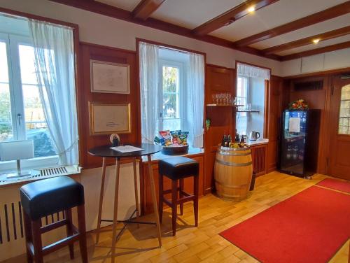 a kitchen with a table and a refrigerator and windows at Boutique-Hotel Krone in Denzlingen