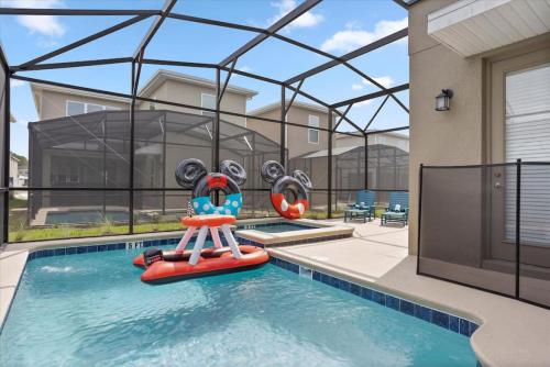 a swimming pool with a inflatable at Modern Resort House Pool Wi-Fi Minutes to Disney in Kissimmee