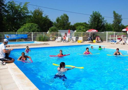 a group of people in a swimming pool at Camping maeva Escapades Les Etangs Mina in Saint-Sornin