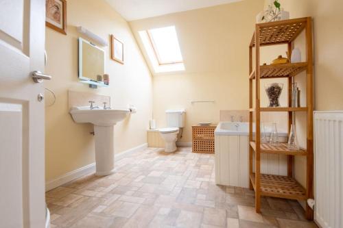 a bathroom with a sink and a toilet at The Steading in Invergordon