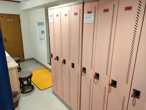 a row of pink lockers in a room at Hotel Edoya in Tokyo