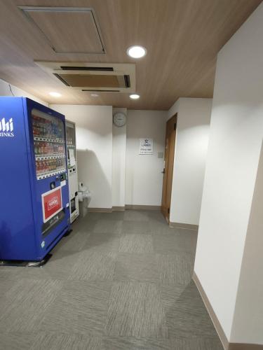 a hallway with a vending machine in a building at Hotel Edoya in Tokyo
