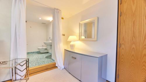 a bathroom with a sink and a toilet and a mirror at The Monument in Newcastle upon Tyne