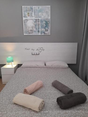 a bedroom with a bed with two towels on it at appartement yumbo europa in Playa del Ingles