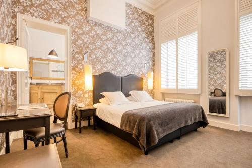 Ένα ή περισσότερα κρεβάτια σε δωμάτιο στο Hotel Made In Louise