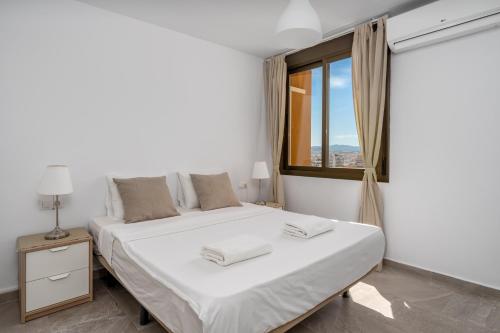 ein weißes Schlafzimmer mit einem großen Bett und einem Fenster in der Unterkunft Fuengirola flat near the movida Ref 170 in Fuengirola