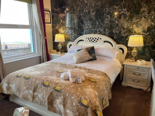 a bedroom with a bed with a teddy bear on it at "The Italian" Seafront Apartment in Eastbourne