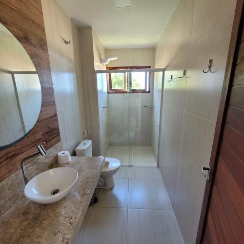 a bathroom with a sink and a toilet and a shower at RANCHO GOSTOSO POUSADA in São Miguel do Gostoso