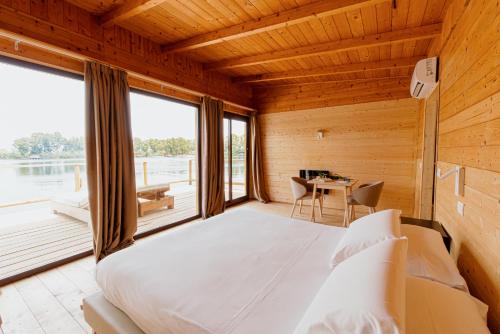 a bedroom with a large bed and a table at Plana Resort & SPA in Castel Volturno