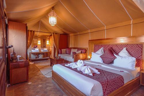 a bedroom with a large bed in a tent at Riad Melhoun & Spa in Marrakech