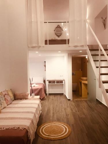 a bedroom with a bunk bed and a staircase at Galanos Katoikies in Órmos Aiyialís