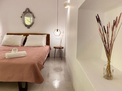 a bedroom with a bed and a mirror at Galanos Katoikies in Órmos Aiyialís