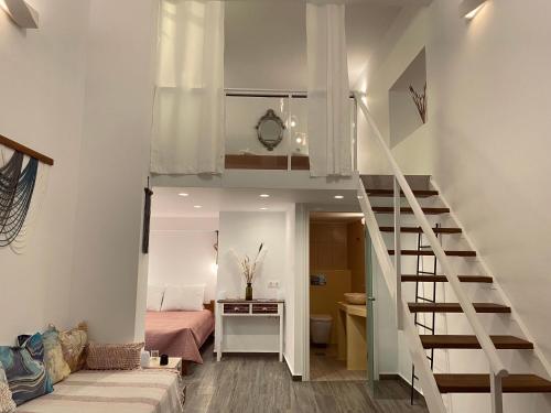 a room with a loft bed and a bedroom at Galanos Katoikies in Órmos Aiyialís