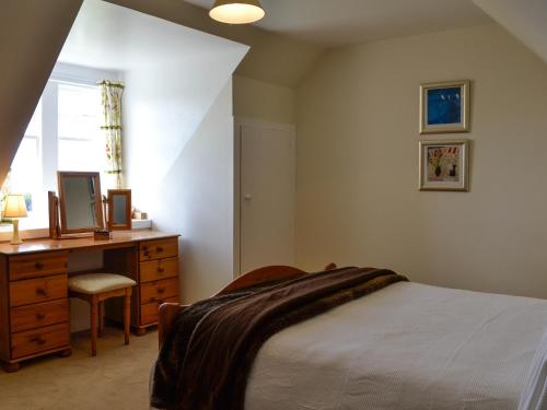 a bedroom with a bed and a dresser and a window at Prospecthill House in Whitehouse