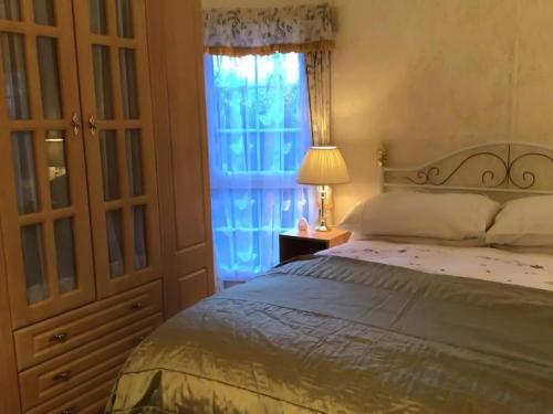 a bedroom with a large bed and a window at Pilgrims Rest 1 - Uk42662 in Ruan Major