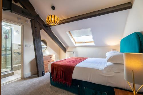 a bedroom with a large bed and a window at The Penthouse At Quayside in York