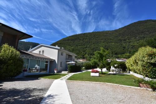 a house with a mountain in the background at Residence Gonda&Giuliano in Borso del Grappa