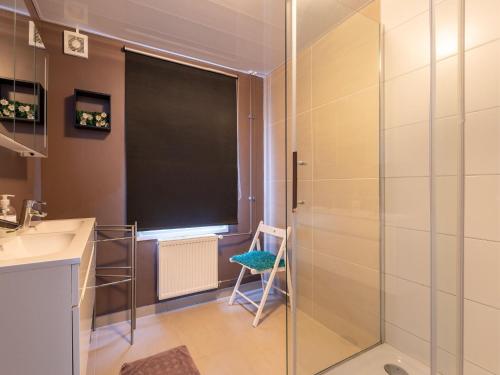 a bathroom with a glass shower and a sink at Holiday Home in Zeeland near Lake in Baarland