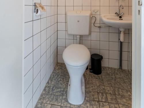 a bathroom with a toilet and a sink at Holiday Home in Zeeland near Lake in Baarland