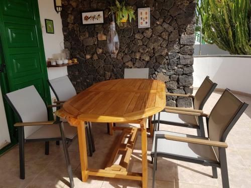 a wooden table and chairs in a room at Casa el Nido in Charco del Palo