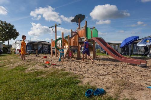 a group of children playing in a playground at Chalet (A16) op gezellige familiecamping bij zee in Kamperland