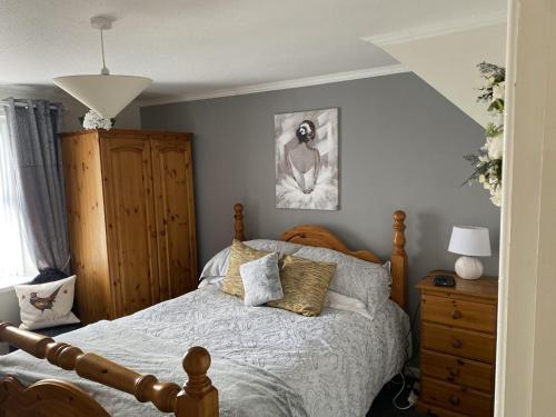 - une chambre avec un lit et des oreillers dans l'établissement Fishermans Cottage, à Killough