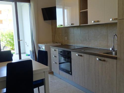 a kitchen with a sink and a stove top oven at Residence San Bull in Metaponto