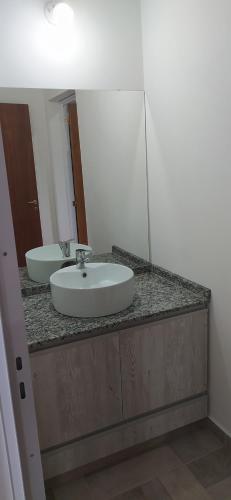a bathroom counter with a sink and a mirror at Cabañas Madre Sierra in Santa Rosa de Calamuchita