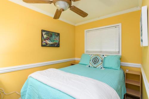 a bedroom with a bed and a ceiling fan at Love Shack in Tybee Island