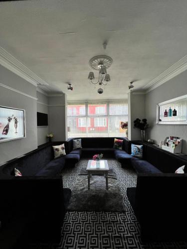 a living room with a couch and a table at Mayfair Hotel in Blackpool