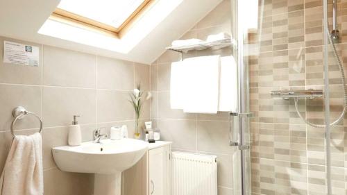 a bathroom with a sink and a shower at Ocean Heights B&B in Lissadell