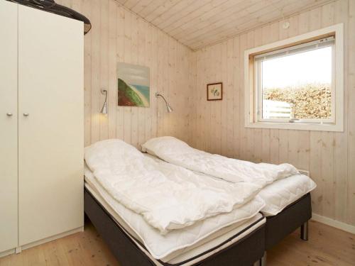 a bed in a room with a window at Two-Bedroom Holiday home in Stege 5 in Grevinge