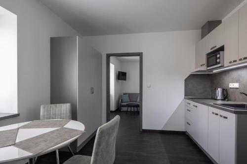 a kitchen and dining room with a table and chairs at Penzion Rozhovice in Rozhovice